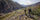Two hunters in Verde Camouflage hiking down a rocky trail while wearing full backpacks