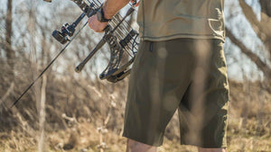 Back of Hunter Holding Bow Wearing Switchback Shorts in Khaki Color