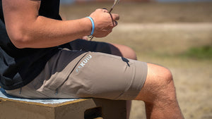 Man sitting on a target block wearing Tiburon 13″ Short in Whetstone Brown