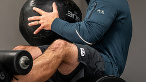 A man working out with a medicine ball.