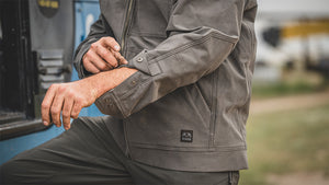Man rolling up the sleeves of his Brawley Fleece Workwear Hoodie