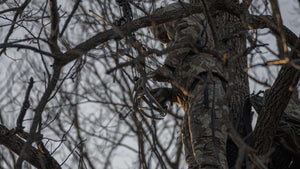 Male hunting for a deer on a tree stand wearing head to toe KUIU Whitetail gear.