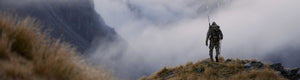 Back of Hunter in Verde Camouflage Overlooking Foggy Valley