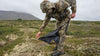 Side of Hunter Unzipping Chugach TR Rain Pants in Valo Camouflage Highlighting YKK Aquaguard Zippers