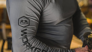 Close-up of “WORKGRADE” logo and hex emblem of a ram printed along the right arm.