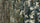 lose-up of camouflage-patterned zippered jacket showing multiple vertical panels with different camo designs in Veros, Valo, Verde, and Vias. The brand name 'KUIU' is visible near the top of several panels.