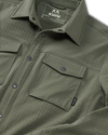 Flat lay highlighting front chest pockets, collar and tagless KUIU label on Blockfield Fleece Shirt in Dark Sage Green