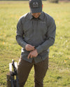 Hunter adjusting his wrist band, wearing Tiburon Hybrid Snap Shirt in Stone Grey