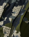 Front of unsnapped buttons on Tiburon Hybrid Snap Shirt in Verde Camouflage