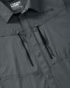 Details highlighting front chest zippered pockets, snap button front placket and accessory loop attachment points on the KUIU Upland Sport Shirt in Gunmetal Grey