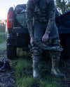 Hunter wearing StrongFleece 290 Layering Pant in Ash Brown underneath KUIU HD Flex Wader