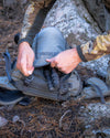 Bottom of Venture Divide 2000 in Stone Highlighting Zippered Passthrough Pocket with Tripod Legs extending past the zipper