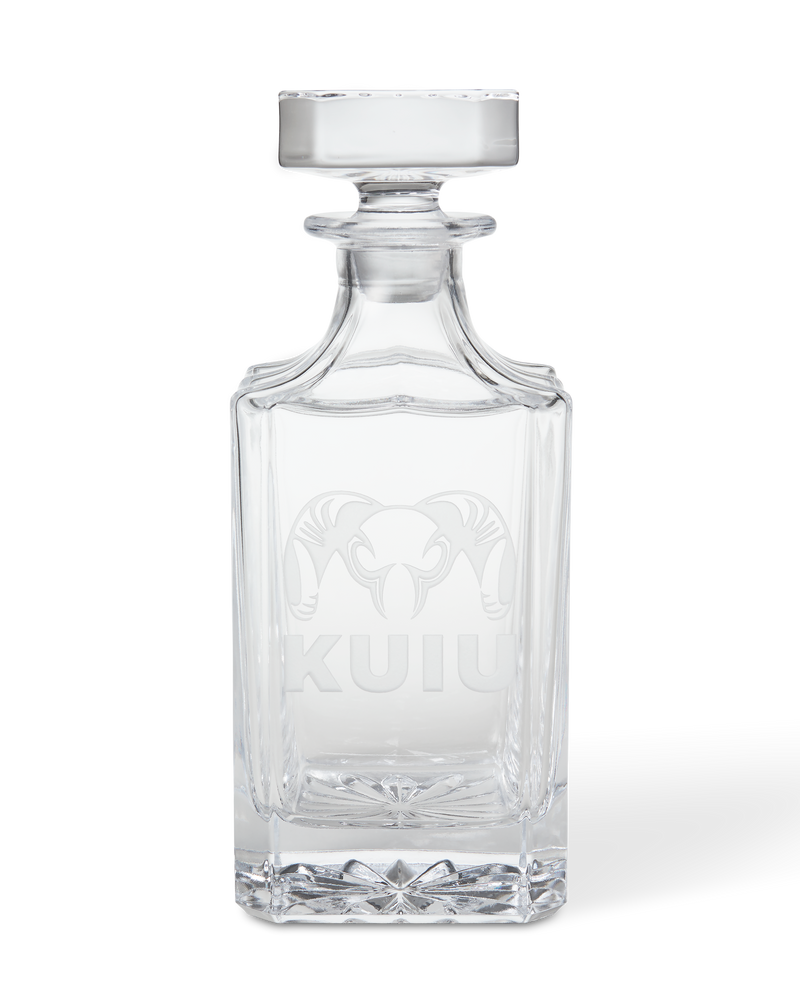 Front of KUIU Engraved Decanter in Clear glass, featuring an etched ram head logo and KUIU text.
