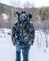Hunter standing facing away from the camera wearing the PRO Divide 4500 Backpack in Verde Camouflage