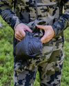 Hunter Utilizing Self Stow Option on Super Down LT Vest in Verde Camouflage