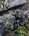 Hunter Watching Game Through Spotting Scope Wearing Women's Super Down LT Jacket and Pants in Verde Camouflage