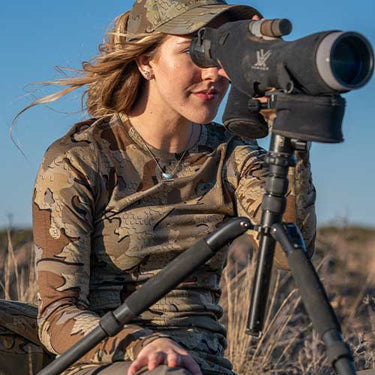 Female hunter glassing in head to toe KUIU Valo Camo.