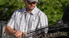 Hunter wearing Borrego Short Sleeve Shirt  adusting the arrows on his bow