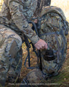 Side of Hunter Pulling 30oz Wide Mouth Waterbottle From Pro LT 7000 Pack in Valo Camouflage