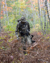 Hunter in the field wearing Valo Camouflage pants, an Ash Pro Bino Harness and the Peloton 240 Full Zip Hoodie in Valo Camouflage